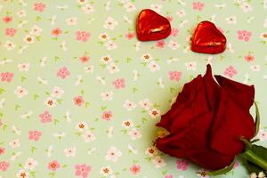 valentines day chocolates and rose on a flower pattern background photo