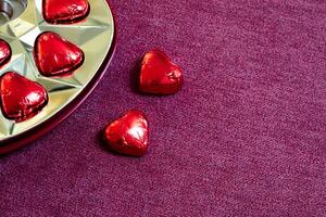 heart shaped chocolates out of a chocolate box with copy space photo