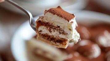 AI generated A close-up of a spoonful of tiramisu, capturing the delicate layers of coffee-soaked ladyfingers and mascarpone photo