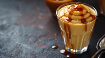 AI generated A luscious butterscotch pudding served in a glass, drizzled with caramel sauce photo