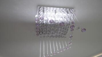 a chandelier with purple and white crystals video