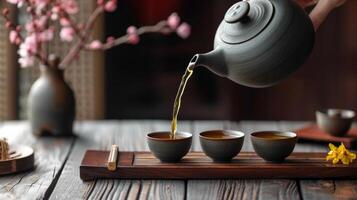 AI generated A tea master pouring tea from a tall ceramic teapot into small cups during a Chinese tea ceremony photo