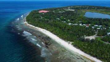 Maldives islands coastline, ocean and tropical beach with palms in Fuvahmulah. Aerial view video