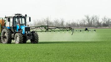 Tractor with a spray device for finely dispersed fertilizer. photo