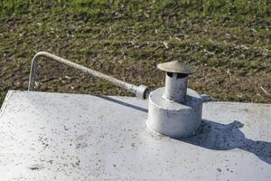 Safety valve on the tank with a tube to drain the liquid photo
