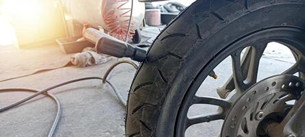 A motorcycle tire is being patched for a puncture. photo