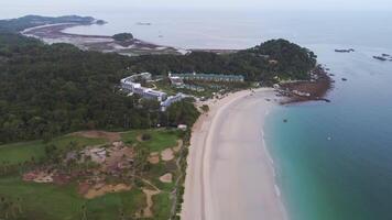 Aerial view beautiful beach and resort hotel on sea coast. Shot. Sandy beach on the sea coast with a rainforest. Scenery of the ocean shore with surf video