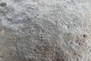 Stone background, stone wall background with rough texture. Abstract, grungy and textured stone material surface. Natural details of rocks. photo