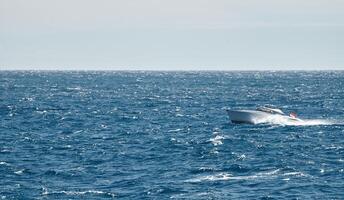 A motorboat is sailing at high speed in the sea near Monaco photo