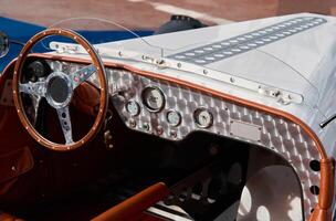 vintage open-top car at the yacht show in Monaco on a sunny day, leather seats, spoked wheels, close-up photo