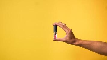 Men's hands give a love gesture on a yellow background photo