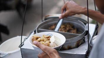 a bowl of meatballs complete with tofu and noodles, street vendors, typical street food from Bandung, West Java photo