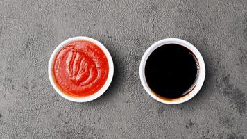 three sauces ketchup mayonnaise, sweet soy sauce and chili sauce in black bowl isolated on white background photo