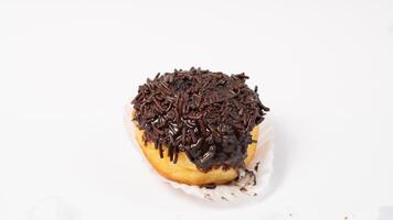 photo of donuts isolated in white background. Donuts with chocolate sprinkles on top