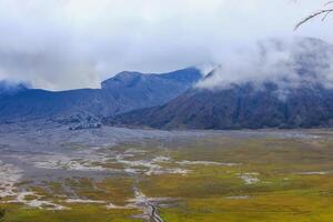 Eruption of Bromo Mountain, white smoke rises from the caldera of Bromo Mount, Indonesia photo