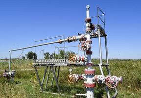 Well for oil and gas production. Oil well wellhead equipment. Oil production photo