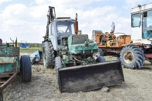 Tractor with a bucket for digging soil. Bulldozer and grader. photo