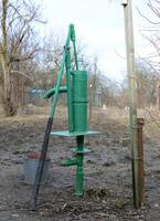 Hand pump leading to an artesian well. photo