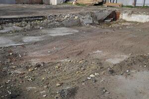 ruined foundation of an old building, the walls of the basement of a demolished building and debris. photo