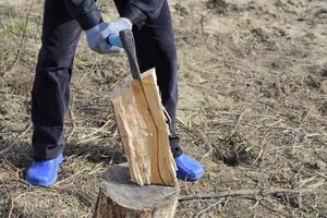 Chopping wood with an ax photo