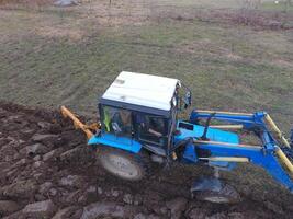 Tractor plowing the garden. Plowing the soil in the garden photo