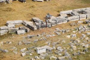 Top view of the excavation site in ruined ancient city of Hierapolis. The remains of destroyed buildings and columns. photo