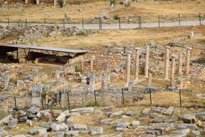 Top view of the excavation site in ruined ancient city of Hierapolis. The remains of destroyed buildings and columns. photo