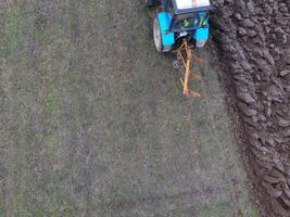 Tractor plowing the garden. Plowing the soil in the garden photo