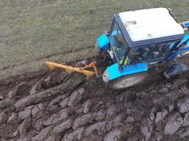 Tractor plowing the garden. Plowing the soil in the garden photo