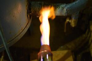 Heating a steel pipe with a blowtorch. The flame of a blowtorch photo