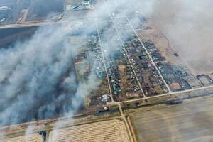 Top view of the small village. Smoke from the burning of straw i photo