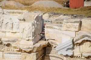 Bas-reliefs of antique scenes on the gables of the amphitheater in Hierapolis, Turkey. photo