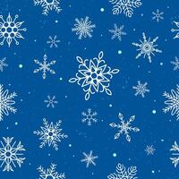 Snowflakes seamless pattern on blue background vector