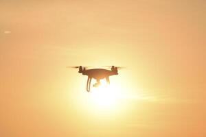 drone silhouette against the background of the sunset photo