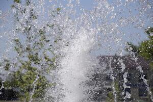 Splashes of a fountain in the park photo