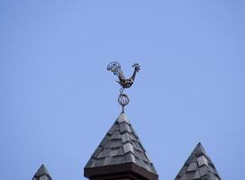 Weathervane in the form of a singing rooster. photo