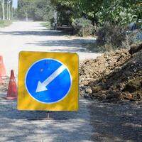 Sign of detour travel. Pit on the road. repair work. photo