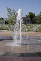 Splashes of a fountain in the park photo