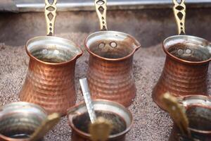 top view of making traditional turkish coffee on sand photo