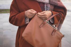 women Unzipping her purse close up photo