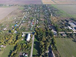 Top view of the village. One can see the roofs of the houses and gardens. Road in the village. Village bird's-eye view photo