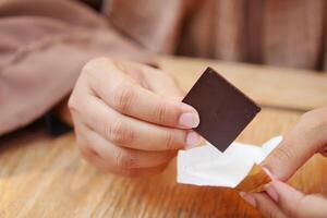 women holding a dark chocolate photo