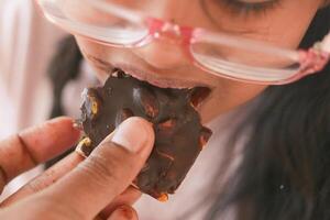 child eating dark chocolate close up photo