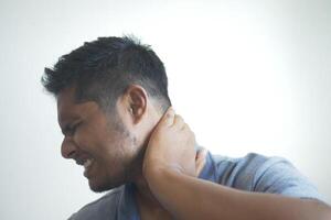 man suffering chronic neck pain photo