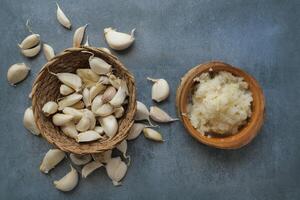 top view of minced garlic on a wooden spoon photo