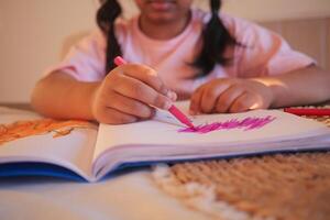 child girl drawing on paper sitting on floor photo