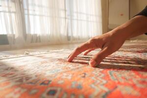 hand touching new home carpet photo