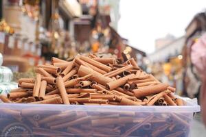 stack of Cinnamon sticks selling on spice bazar photo