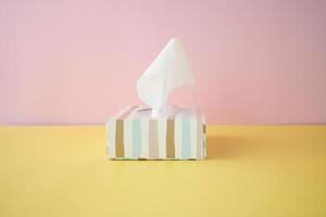 tissue in a box on color background photo