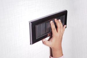 child finger turning on lighting switch with copyspace photo